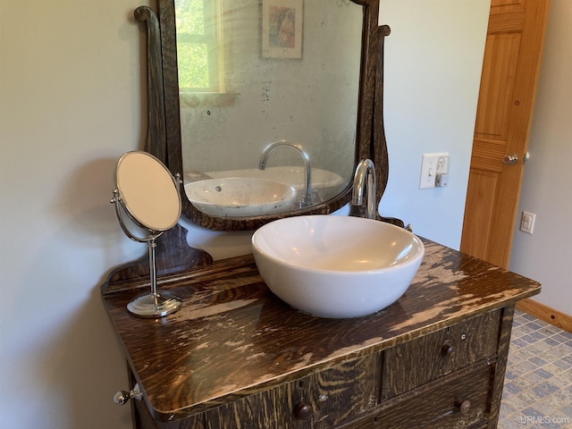 bathroom featuring vanity and baseboards