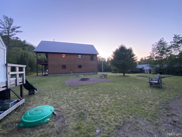 view of yard with an outdoor fire pit