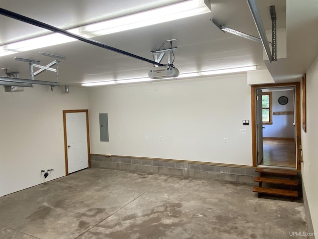 garage with a garage door opener and electric panel