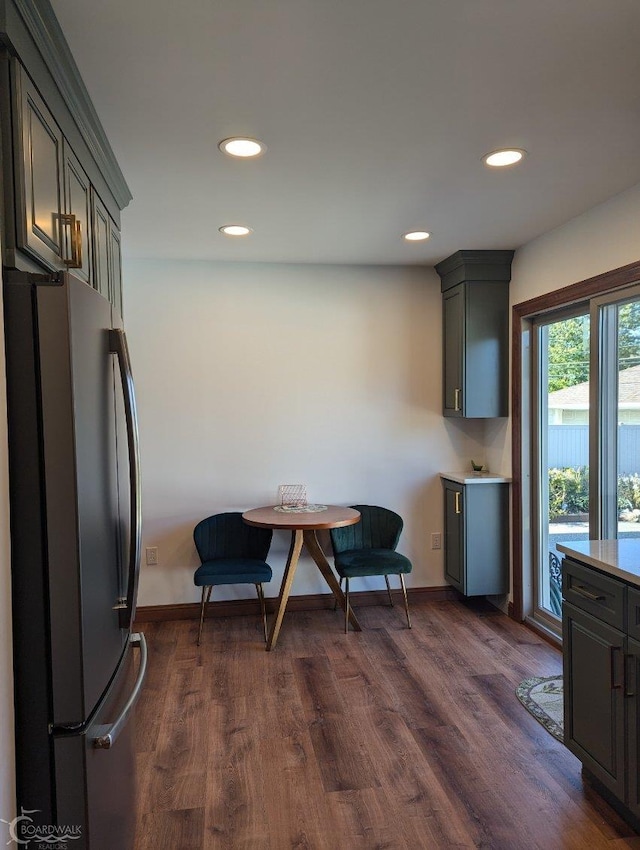 kitchen featuring stainless steel refrigerator, dark hardwood / wood-style flooring, and gray cabinetry