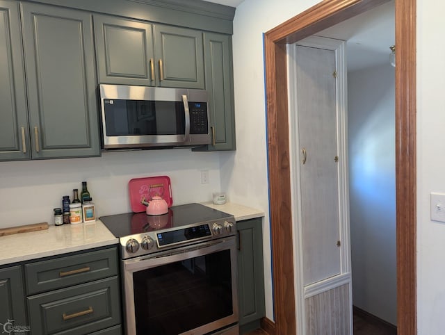 kitchen featuring gray cabinets and appliances with stainless steel finishes