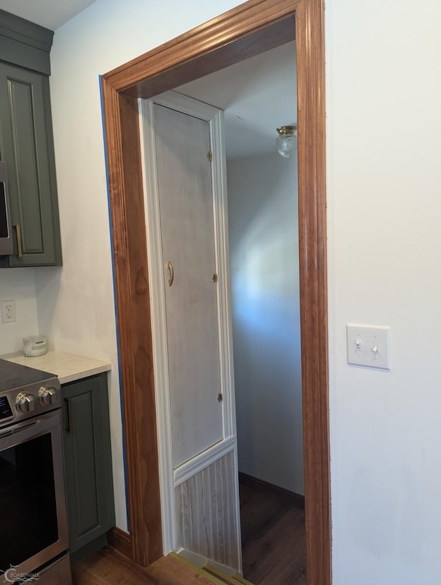 kitchen with electric range and dark wood-type flooring