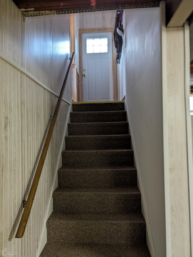 stairway with wood walls