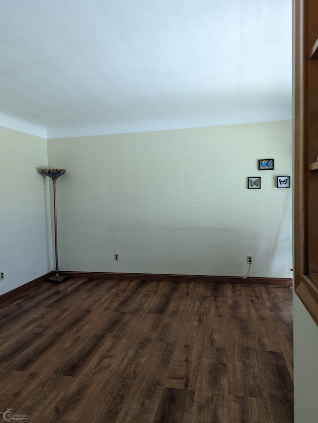 spare room featuring dark hardwood / wood-style flooring