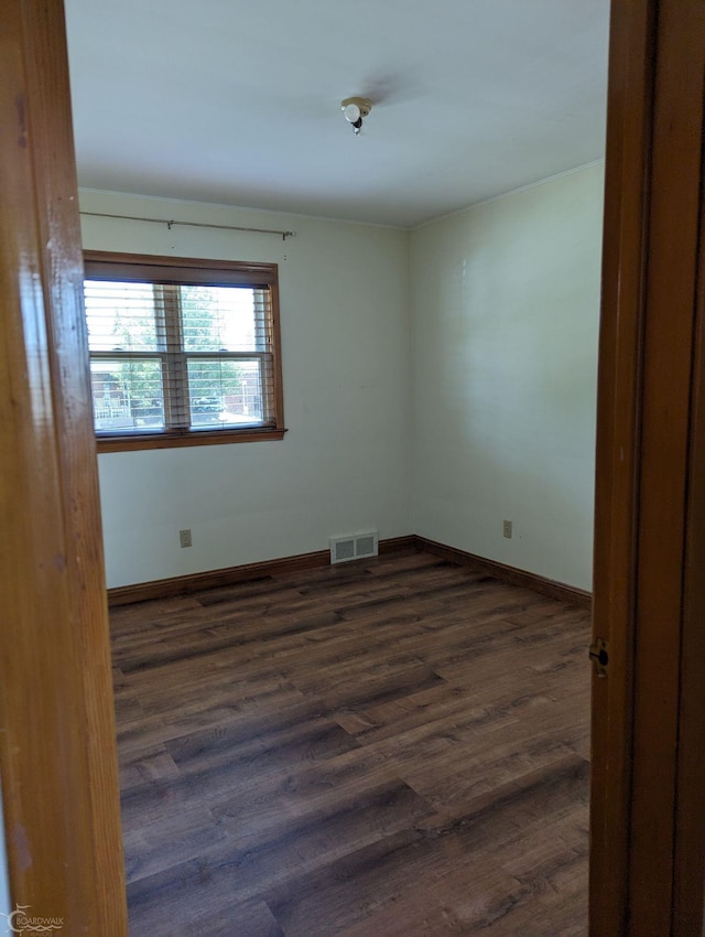 spare room with dark hardwood / wood-style floors