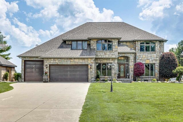 view of front facade featuring a garage and a front lawn