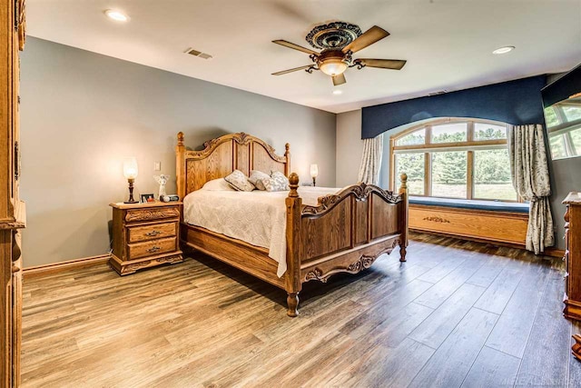 bedroom with ceiling fan and hardwood / wood-style flooring