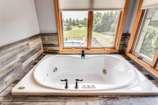 full bath featuring a tub with jets