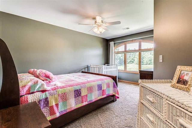 bedroom featuring light carpet and ceiling fan