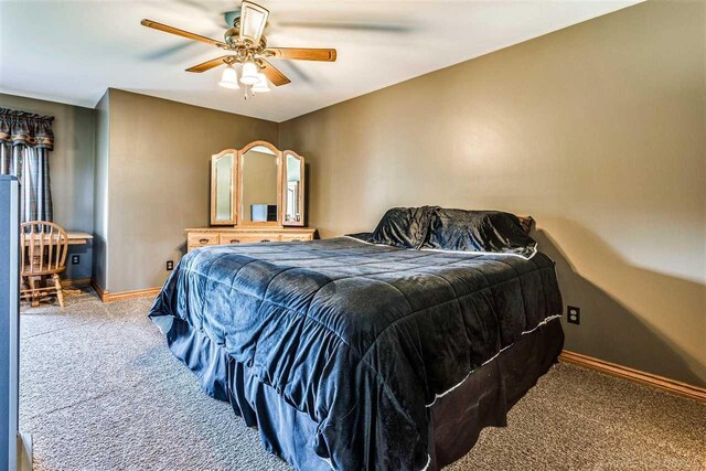 bedroom with carpet, a ceiling fan, and baseboards