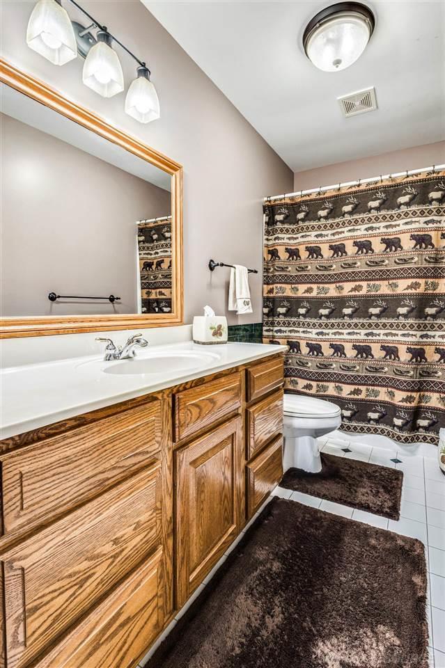 bathroom featuring vanity, tile patterned floors, and toilet