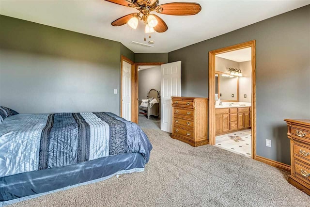 bedroom featuring ensuite bath, ceiling fan, and light tile patterned floors