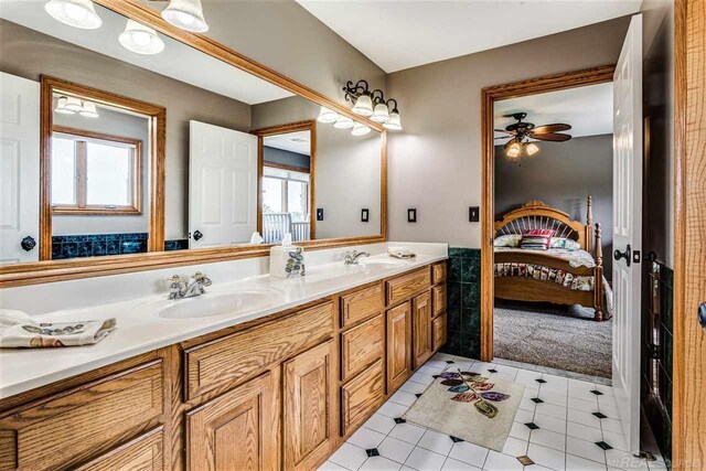 bathroom with dual vanity, ceiling fan, and tile patterned floors