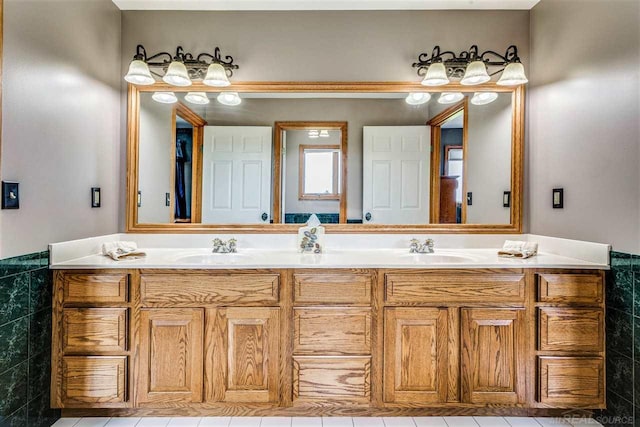 bathroom with tile patterned flooring, tile walls, and dual vanity