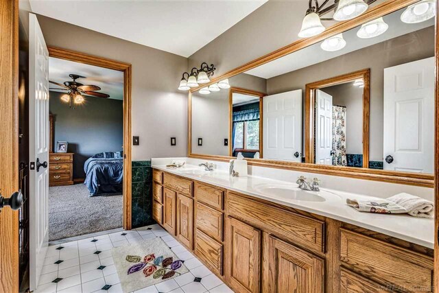 bathroom featuring ceiling fan, dual bowl vanity, and tile patterned flooring