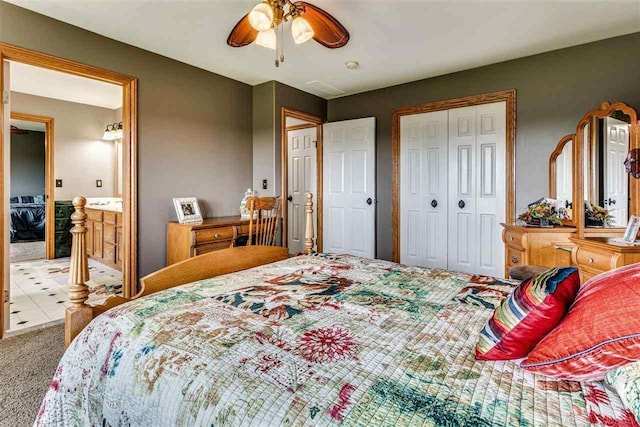 carpeted bedroom featuring a ceiling fan, a closet, and ensuite bathroom