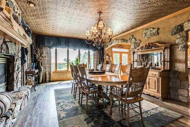 dining area with dark wood-style floors, an ornate ceiling, crown molding, and french doors