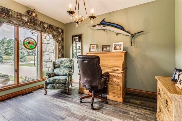 office with dark hardwood / wood-style flooring and an inviting chandelier