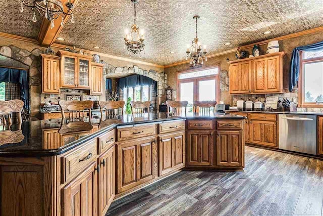 kitchen with dishwasher, glass insert cabinets, dark countertops, and an ornate ceiling