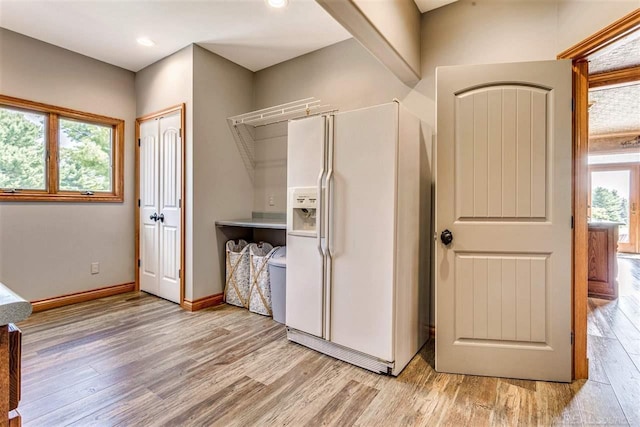 kitchen with baseboards, white refrigerator with ice dispenser, recessed lighting, and light wood-style floors