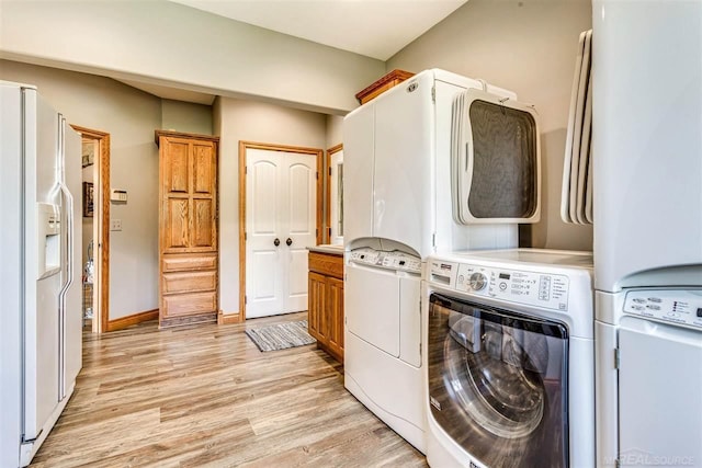 washroom featuring washer and clothes dryer and light hardwood / wood-style flooring