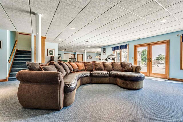 carpeted living room featuring french doors and a paneled ceiling