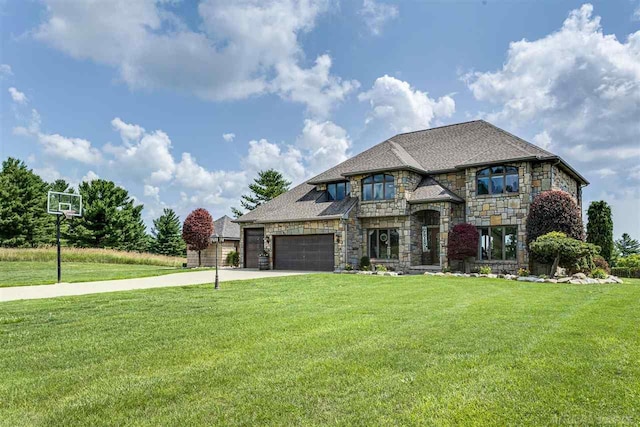 view of front of property featuring an attached garage, stone siding, concrete driveway, and a front yard