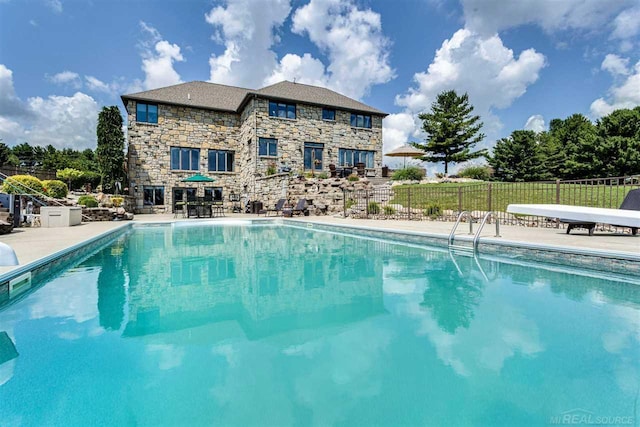 view of pool featuring a fenced in pool, a patio area, and fence