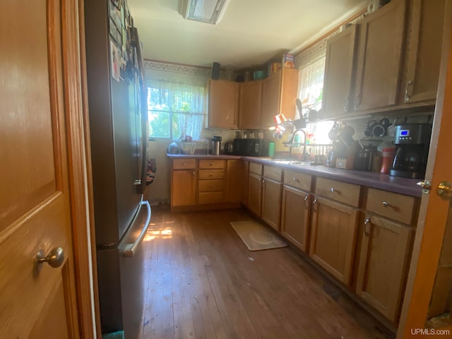 kitchen featuring hardwood / wood-style flooring, light brown cabinets, and sink