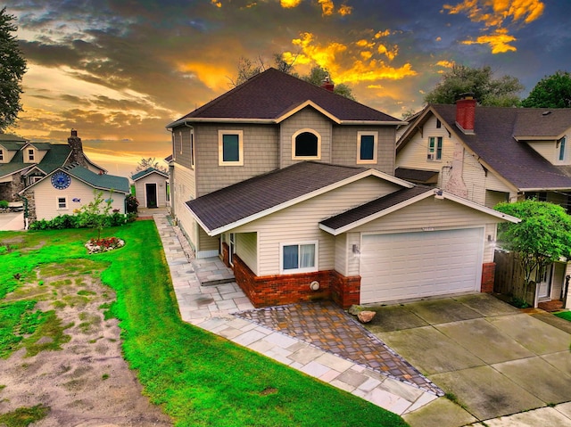 view of front of property featuring a garage and a lawn