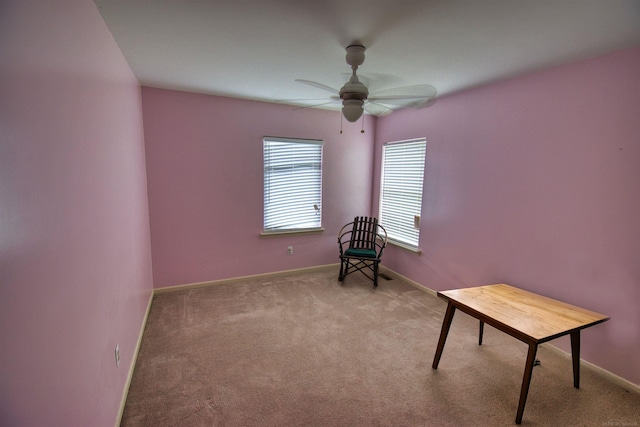 sitting room with ceiling fan and light carpet