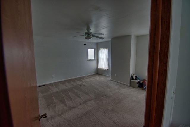 carpeted empty room with ceiling fan