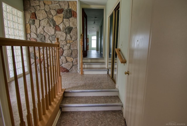 stairway featuring tile patterned flooring