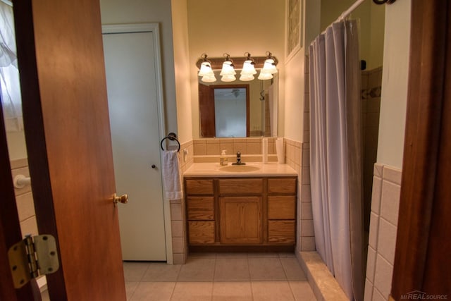 bathroom featuring tile patterned flooring, vanity, tile walls, and a shower with shower curtain