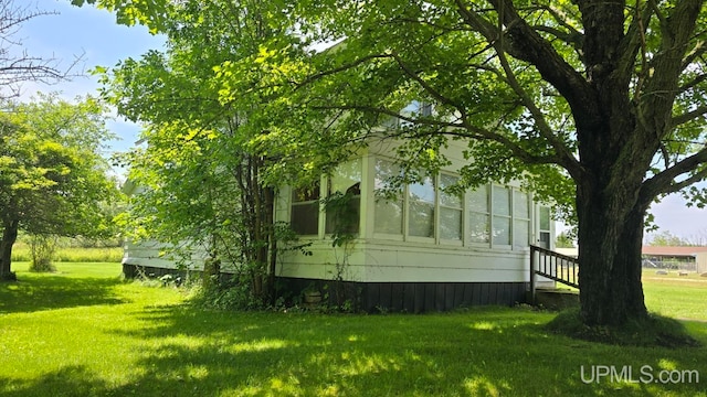 view of home's exterior featuring a lawn