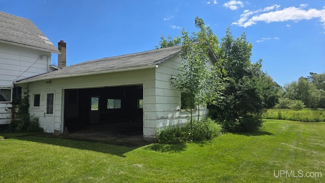 view of side of home with a lawn