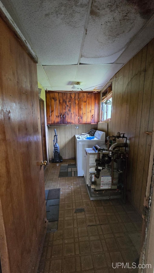 kitchen with wood walls and independent washer and dryer