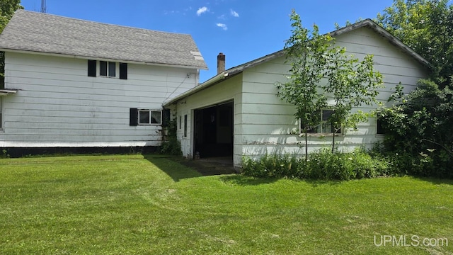 back of property with a yard