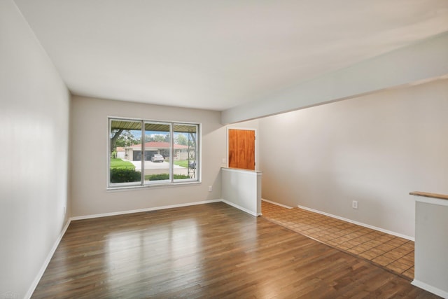 spare room with dark hardwood / wood-style floors