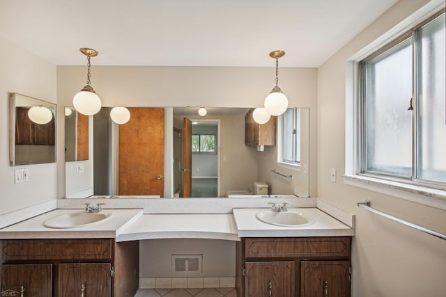 bathroom with tile patterned flooring, vanity, and toilet