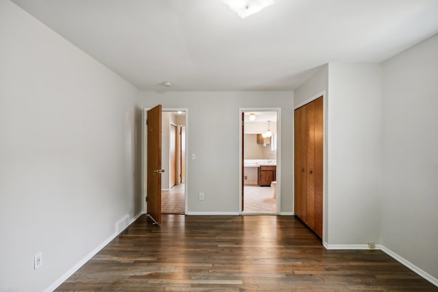 spare room featuring dark wood-type flooring