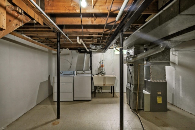 basement with washing machine and dryer and sink