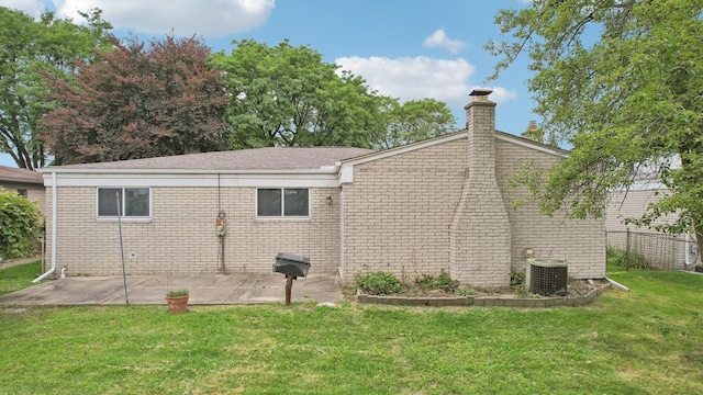 view of property exterior with central AC unit, a patio area, and a lawn