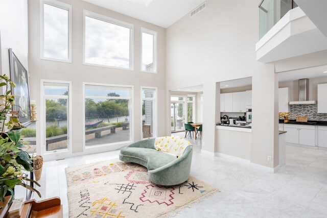 living room with a high ceiling and light tile patterned floors