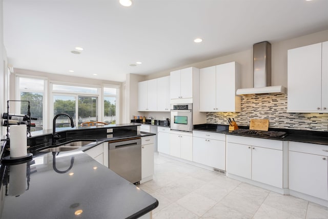 kitchen featuring stainless steel appliances, white cabinets, sink, light tile patterned flooring, and wall chimney exhaust hood