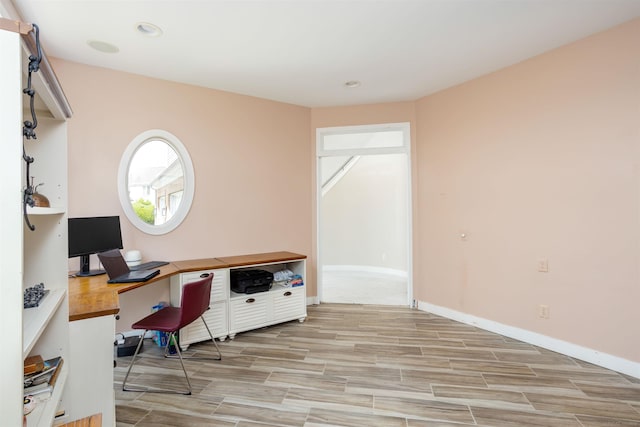 office area featuring light carpet