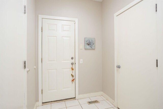 foyer featuring light tile patterned flooring