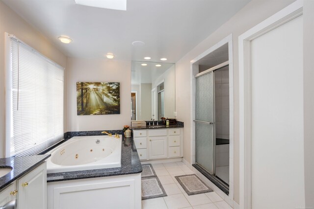 bathroom featuring tile patterned floors, plus walk in shower, and vanity