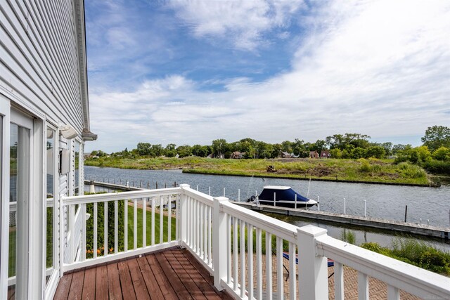 deck with a water view and a boat dock