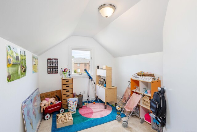 playroom with carpet floors and vaulted ceiling